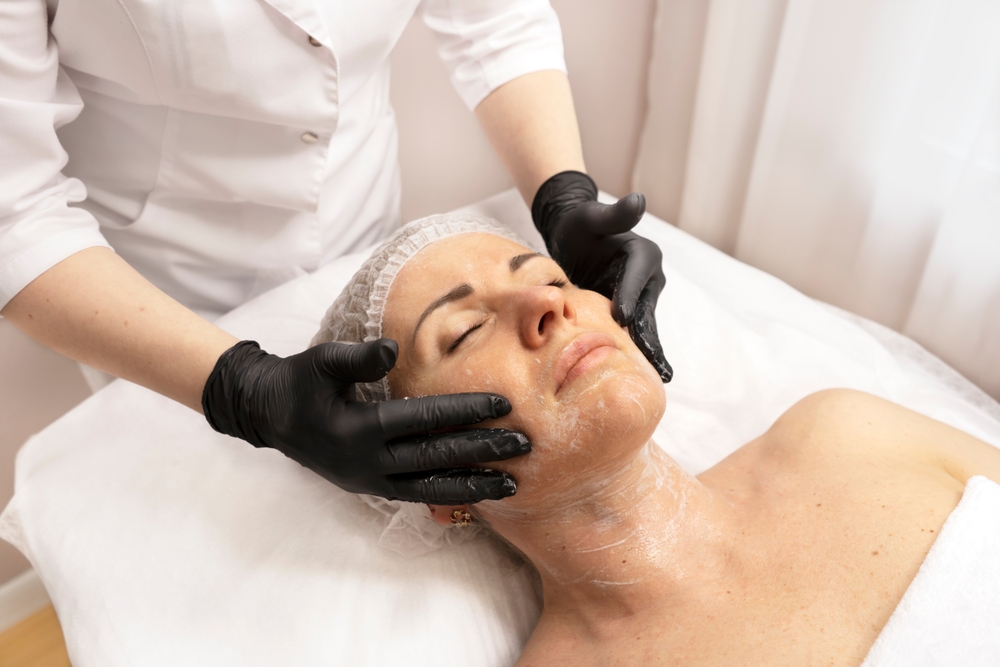 Young,beautiful,woman,getting,facial,care,and,peeling,by,beautician