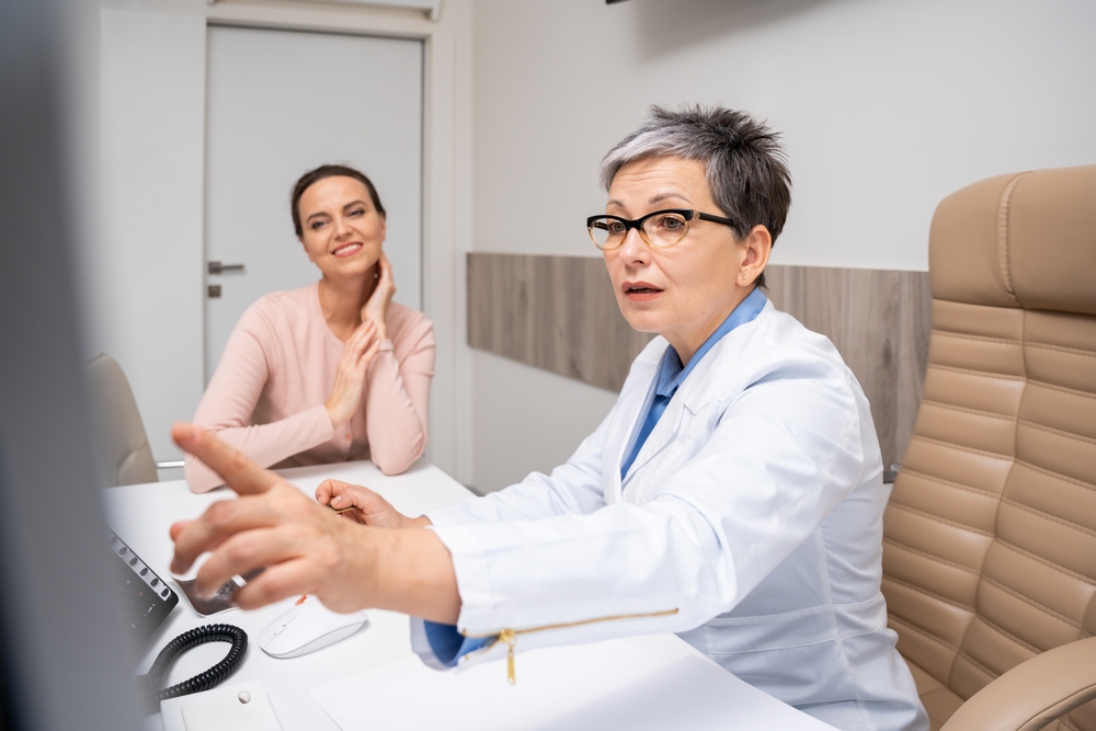 A,doctor,and,patient,converse,during,an,ultrasound,appointment.