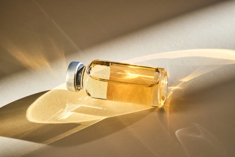 Injection,vial,with,medicinal,product,in,sunlight,on,beige,background.