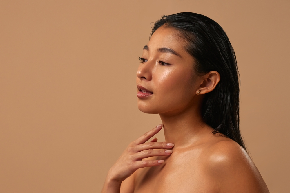 Asian,Woman,With,Clear,Glowing,Skin,Posing,Isolated,On,Beige