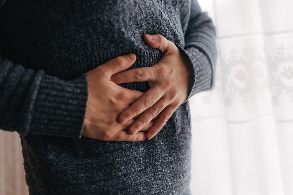 Man,Holding,His,Stomach,In,Discomfort,From,Pain,Or,Acid Comprehensive Weight Loss Symptom Management Protocols